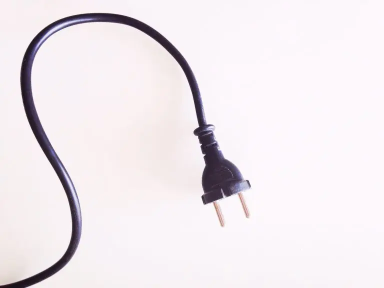 Against a blank background, an electrical cord with a two-prong plug is used to represent website plugins.