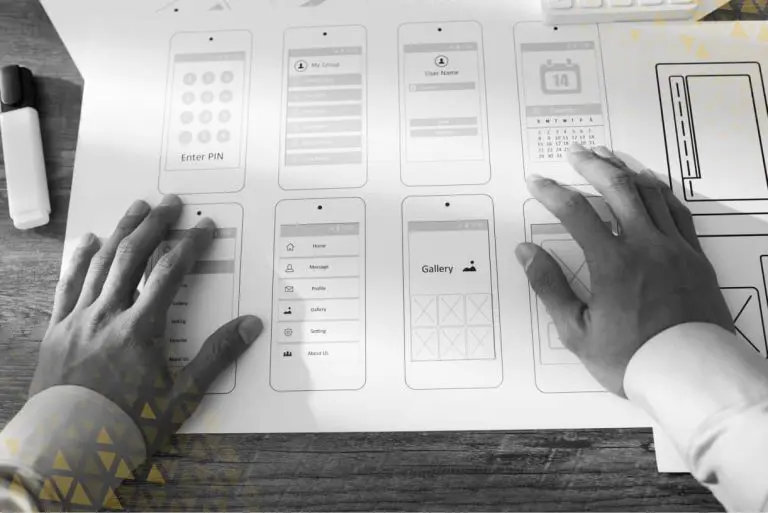 designer laying hands over wireframe sketches
