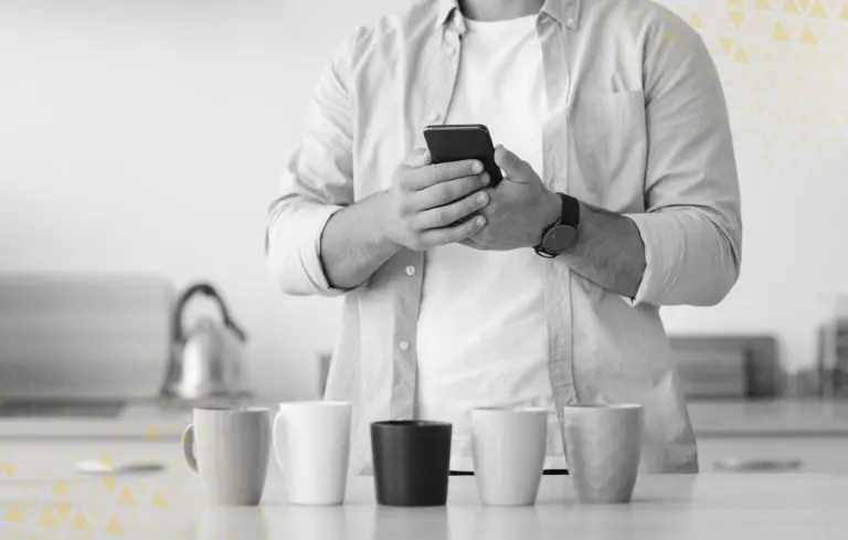 man with coffee mugs taking photos