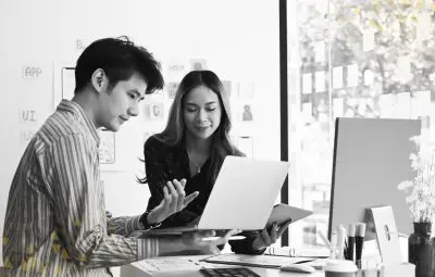 two young professionals looking at laptop