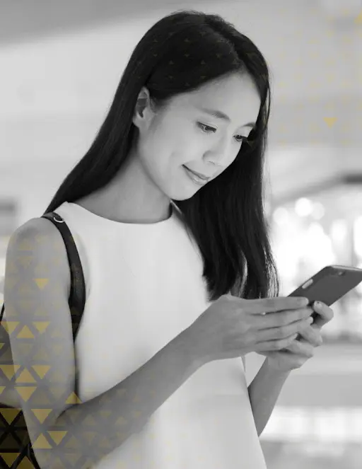 asian lady in white shirt looking at her phone