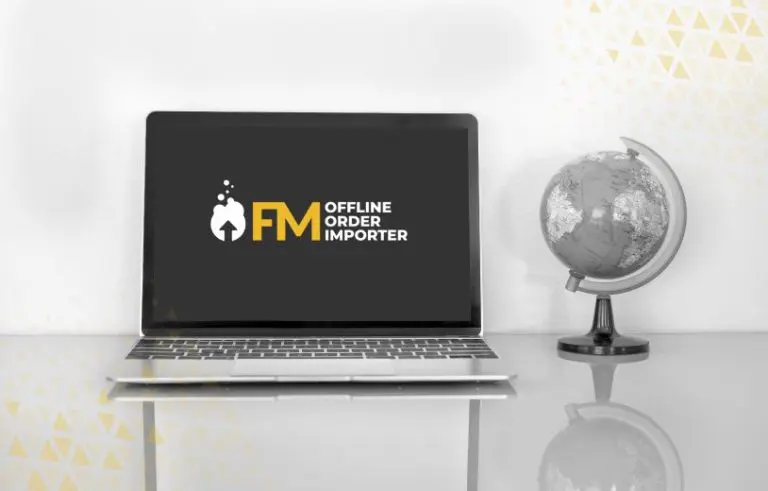 laptop on desk with FM logo app