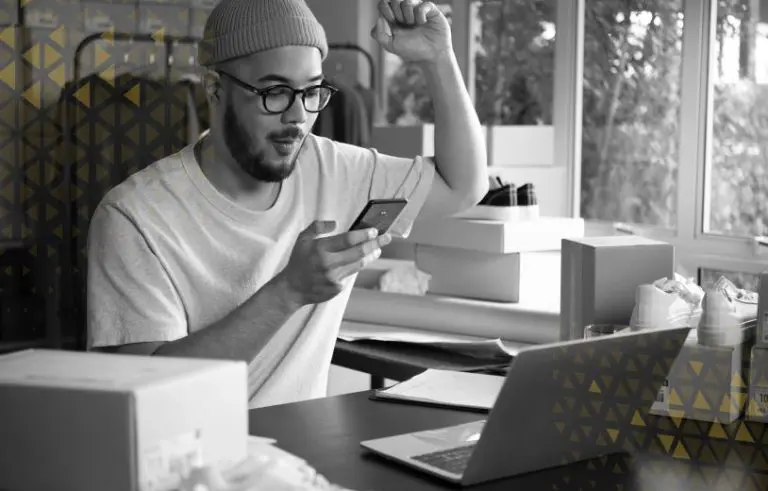 man excited while looking at smartphone