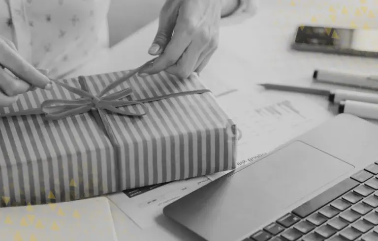 close up of hands opening a gift