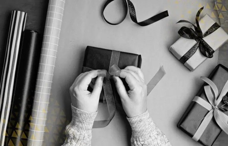 two hands wrapping a present