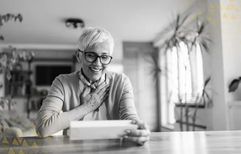 old woman smiling at tablet