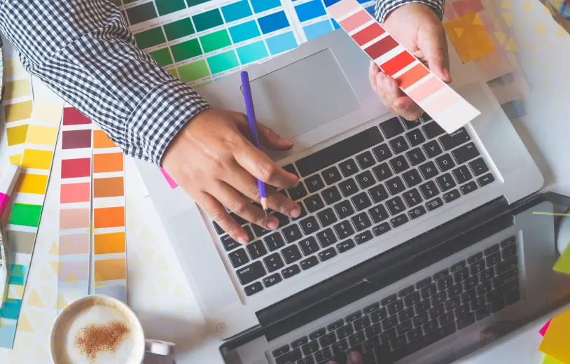 laptop surrounded by color pallets