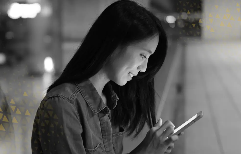 a woman on the street looking at her phone